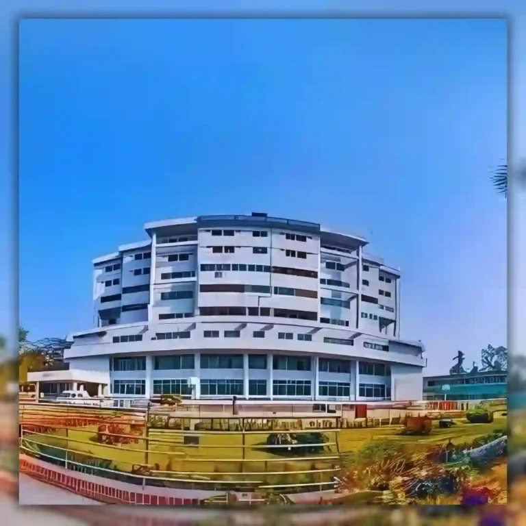 Modern multi-story building with a curved design under a clear blue sky.